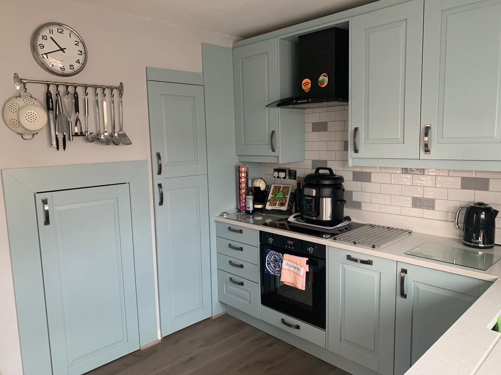 Freshly cleaned kitchen with pale blue cabinets